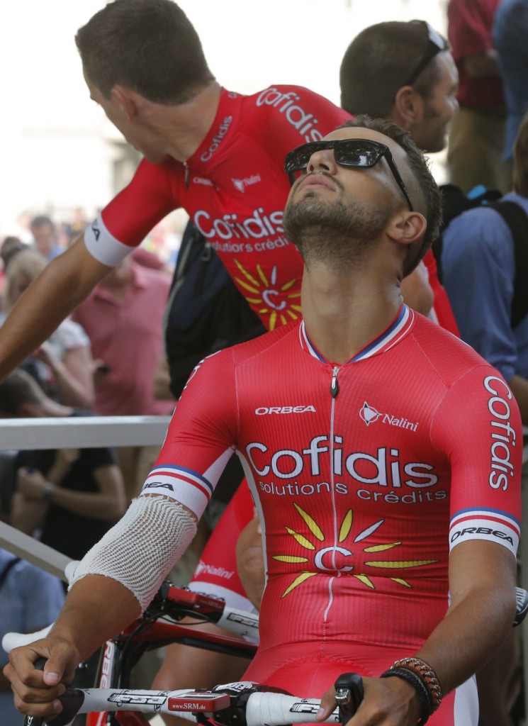In this image taken Thursday July 2, 2015, Nacer Bouhanni of France looks up to the skies as he waits for the Tour de France cycling teams presentation in Utrecht, Netherlands. Battered and bruised following his crash at France's national championship last week, up and coming sprinter Nacer Bouhanni will finally be on the starting line when the Tour starts on Saturday in Utrecht. (AP Photo/Christophe Ena)